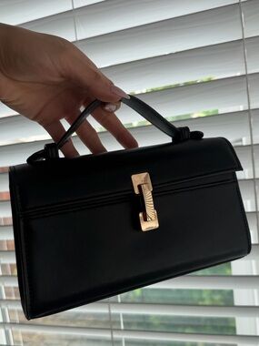 Elegant Black Leather Top-Handle Crossbody Bag with Gold Accent